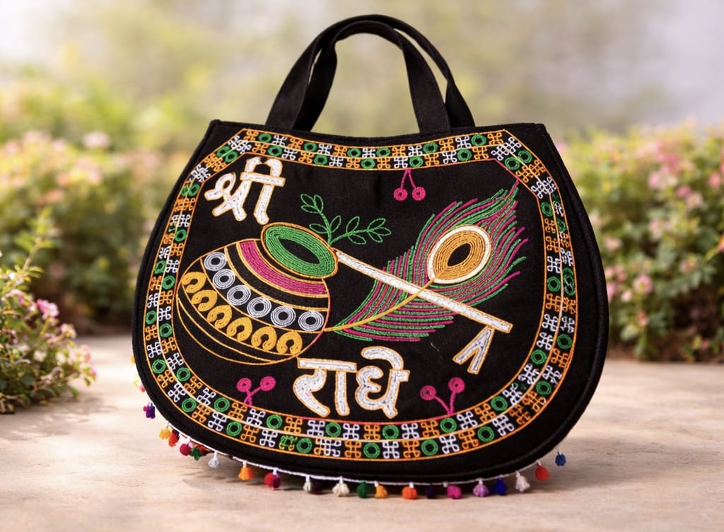 Decorative handbag with intricate patterns and text on a wooden surface with a blurred natural background
