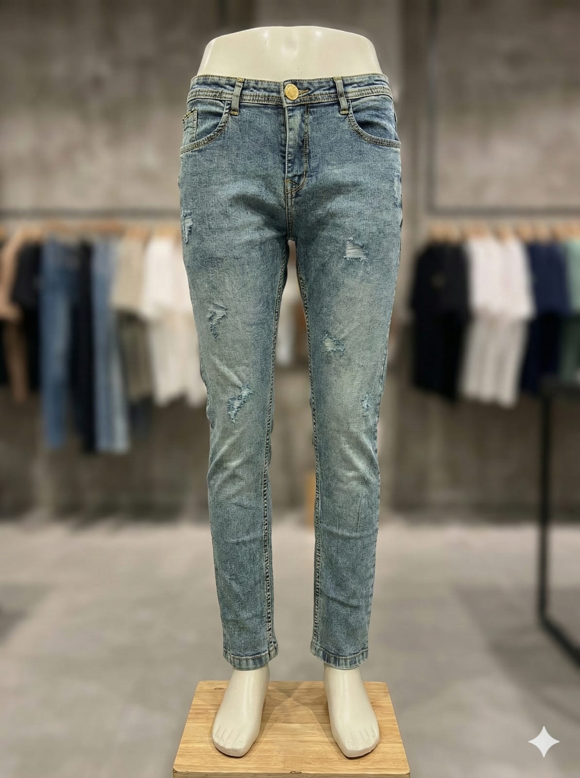 Blue jeans on a mannequin with a blurred clothing rack 