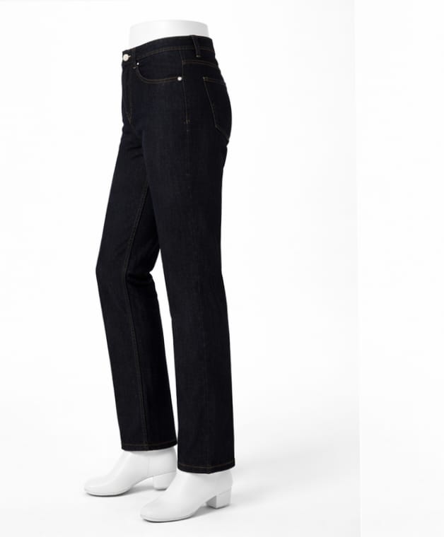 Black jeans on a mannequin with white shoes against a white background