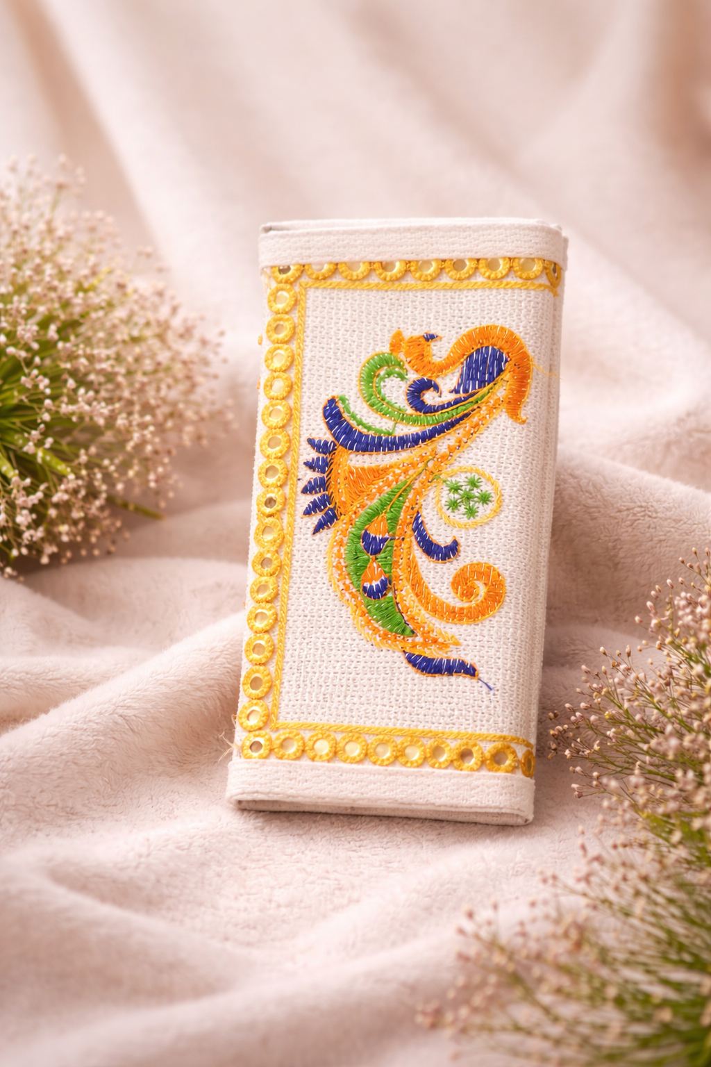 Embroidered wallet  with decorative design on a soft fabric background