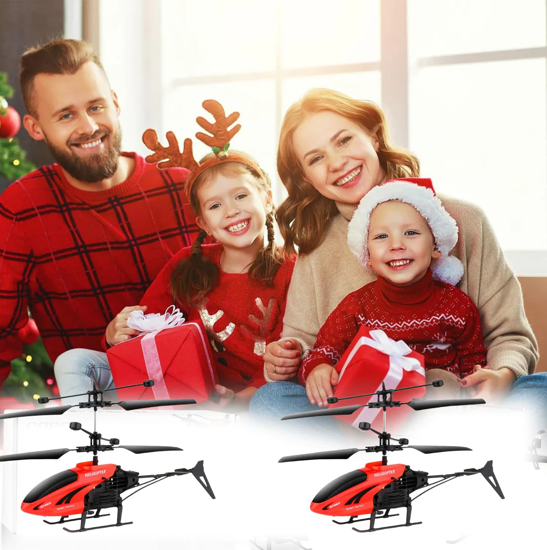 Family of four with Christmas decorations and two toy helicopters in the foreground.