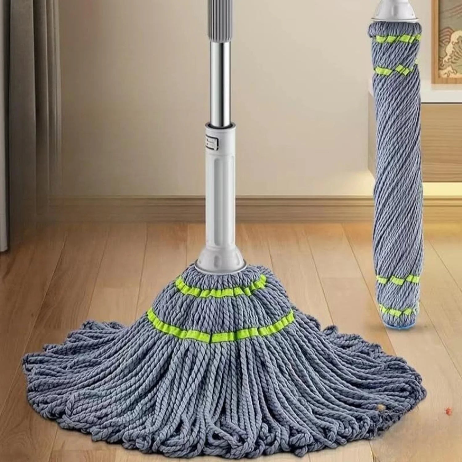 Mop with a wide head and a smaller handle on a wooden floor.