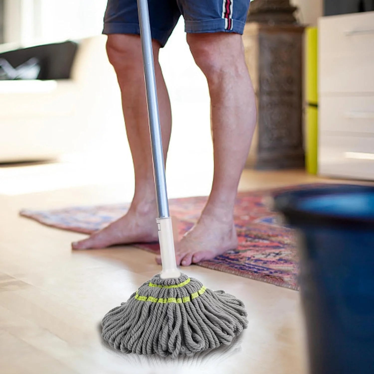 Person cleaning a floor with a mop in a home setting