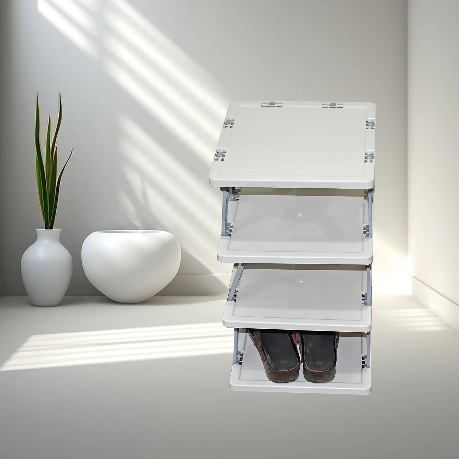 White folding step ladder with shoes underneath on a light gray floor.